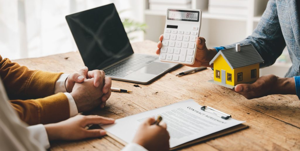 Real estate agents deliver replica homes to couples. Mortgage agreements, loans, leases, self managed super fund, rental income, property management, purchase property, self managed super, smsf property loan, home loans