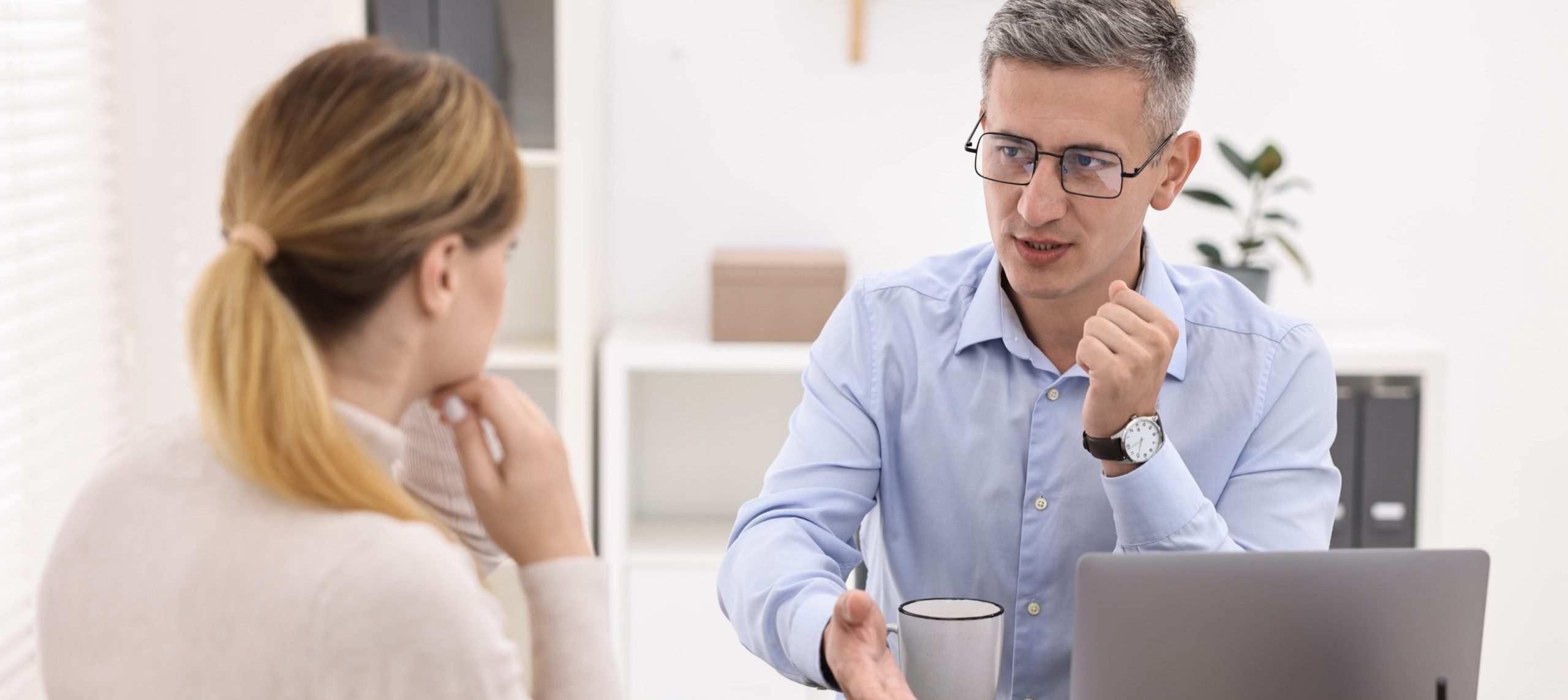 Banker working with client at table in office