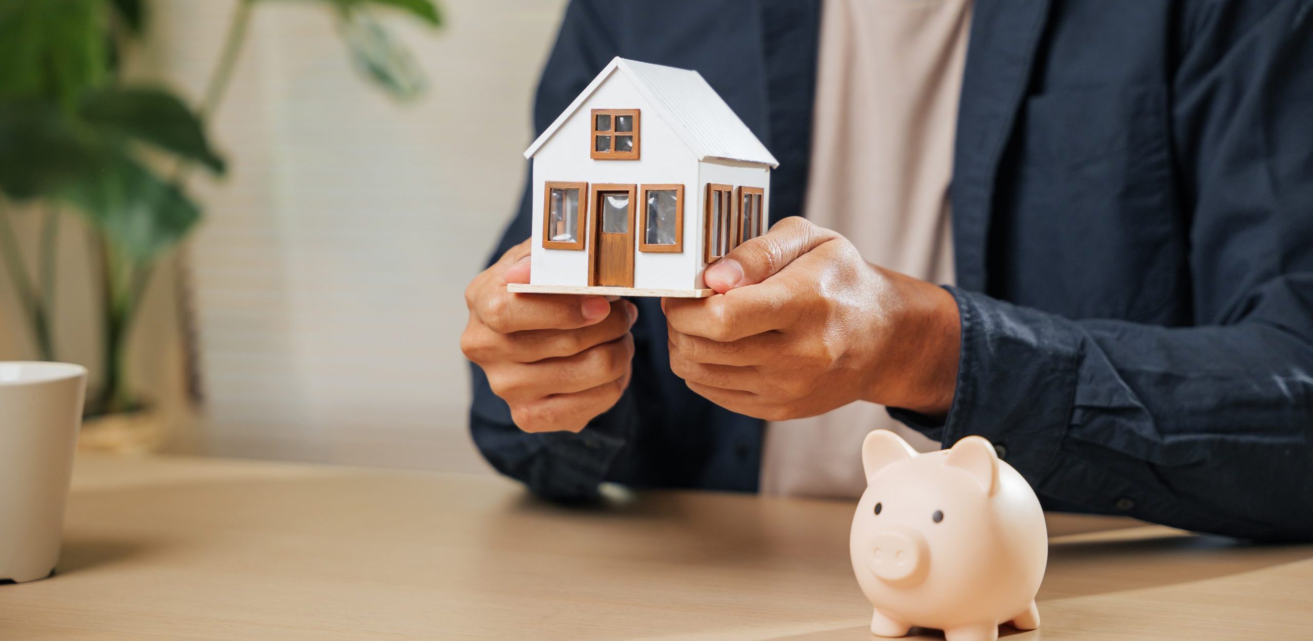 First Home Buyers Maroochydore property investment sunshine coast Hands holding a house model and piggy bank, symbolizing mortgage, loan, and property concepts, capital growth, gold coast, wealth, investment, clients, business, week, proces, achieve