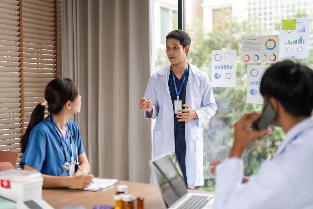 Healthcare meeting: Medical team discussing treatment strategies at office