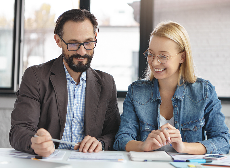 blonde woman having conversation with work colleague 1 Services