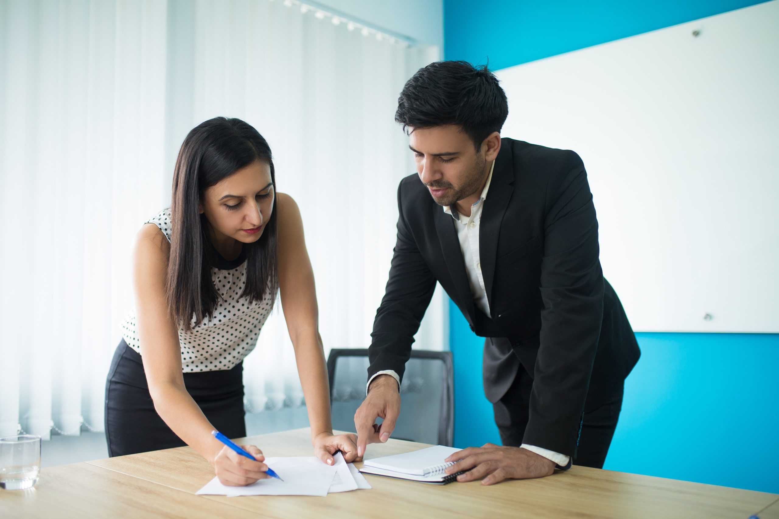 serious businessman businesswoman signing contract 2 scaled Services